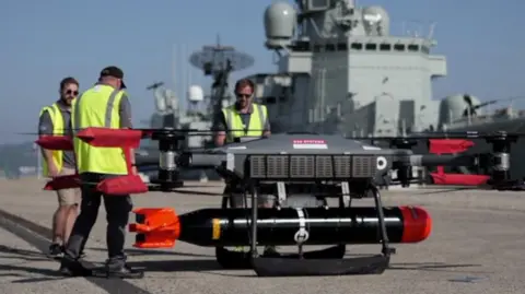 39f50fe0-2ce5-11f0-b9d2-ffe9aa23cdd0 39f50fe0-2ce5-11f0-b9d2-ffe9aa23cdd0 Three men wearing hi-vis jackets stand round a drone carrying a missile UK prepared to pay to access EU defence programmes 39f50fe0 2ce5 11f0 b9d2 ffe9aa23cdd0