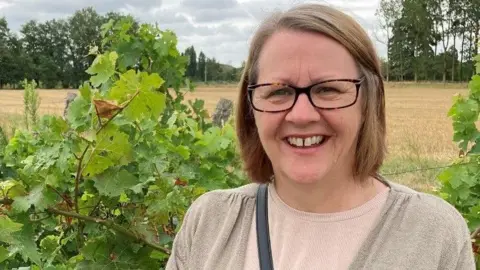 51cf2af0-3b96-11f0-832f-6950cce6e656 51cf2af0-3b96-11f0-832f-6950cce6e656 NHS Sussex Woman smiles at the camera, wearing glasses with green fields in the background 'I'm tackling my diabetes risk for my grandson' 51cf2af0 3b96 11f0 832f 6950cce6e656