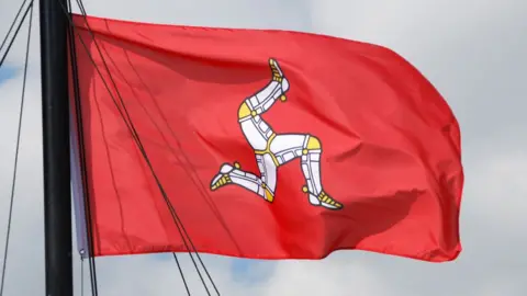 57f3a220-f2bd-11ef-896e-d7e7fb1719a4 57f3a220-f2bd-11ef-896e-d7e7fb1719a4 Getty Images The Isle of Man flag, coloured red with the triskelion in the middle, flies in the wind. The triskelion is an image of three legs in armour, fitted with golden spurs. first place in british isles set to approve right to die First place in British Isles set to approve right to die 57f3a220 f2bd 11ef 896e d7e7fb1719a4