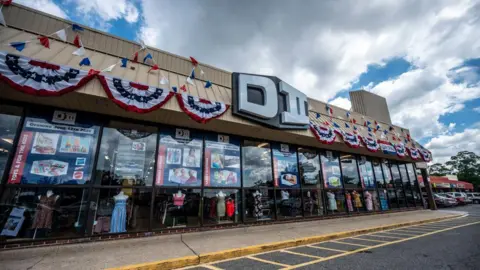 65350740-3001-11f0-b79a-3fe8d6dd3f8f 65350740-3001-11f0-b79a-3fe8d6dd3f8f Newsday/Getty The exterior of the Brooklyn, New York based DII discount store in Bellmore, New York on July 1, 2020 'I can get my Christmas tree order' – firms give sigh of relief at tariff truce 65350740 3001 11f0 b79a 3fe8d6dd3f8f