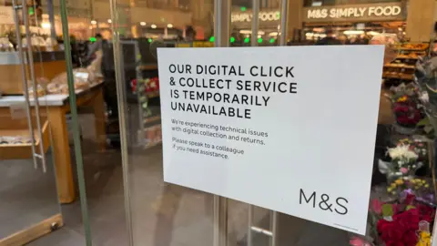 8b326ad0-24f5-11f0-a669-f39b891d9395 8b326ad0-24f5-11f0-a669-f39b891d9395 A white sign on the door of a Marks and Spencer branch in London reads "our digital click & collect service is temporarily unavailable" in large capital letters. Underneath it says: "We're experiencing technical issues with digital collection and returns. Please speak to a colleague if you need assistance." online orders paused and missing items – what we know about the m&s cyber chaos Online orders paused and missing items – what we know about the M&S cyber chaos 8b326ad0 24f5 11f0 a669 f39b891d9395