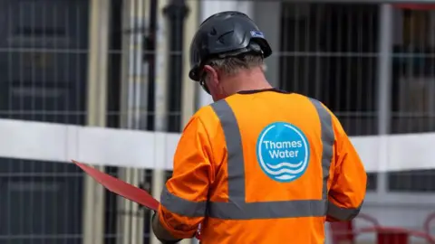 9e9f9620-3bba-11f0-9010-29da954f4c19 9e9f9620-3bba-11f0-9010-29da954f4c19 Getty Images A Thames Water employee wearing a hi-vis uniform reads a document inside a red folder while on a site Thames Water hit with biggest ever penalty over sewage and dividend breaches 9e9f9620 3bba 11f0 9010 29da954f4c19