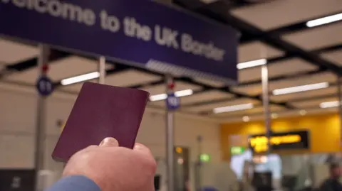 c76997f0-3574-11f0-8519-3b5a01ebe413 c76997f0-3574-11f0-8519-3b5a01ebe413 BBC Man holds up passport with e-gates in background Doubts over whether Brits can use EU e-gates this summer Doubts over whether Brits can use EU e-gates this summer c76997f0 3574 11f0 8519 3b5a01ebe413