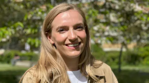 cb7e4350-2501-11f0-b324-e10b0a7b708d cb7e4350-2501-11f0-b324-e10b0a7b708d BBC Dr Ellie Irwin faces the camera, smiling, with long blond hair in a sunny outdoor place with blurred trees in the background woman's eyesight saved by cutting-edge test after mystery infection Woman's eyesight saved by cutting-edge test after mystery infection cb7e4350 2501 11f0 b324 e10b0a7b708d
