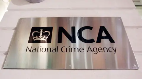 cfdde580-f2d0-11ef-84f0-69dd5e31f970 cfdde580-f2d0-11ef-84f0-69dd5e31f970 PA Media Photograph of a metallic sign outside the National Crime Agency headquarters in central London. michelle mone-linked ppe firm evidence to be heard in private Michelle Mone-linked PPE firm evidence to be heard in private cfdde580 f2d0 11ef 84f0 69dd5e31f970