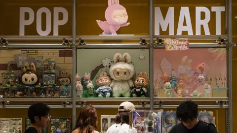 0b74c770-4cf0-11f0-9604-9d8ffb525450 0b74c770-4cf0-11f0-9604-9d8ffb525450 Getty Images Customers browse a Pop Mart display filled with Labubu characters and collectible figures from The Monsters series on June 16, 2025 in Chongqing, China. Adorable or just weird? How Labubu dolls conquered the world 0b74c770 4cf0 11f0 9604 9d8ffb525450