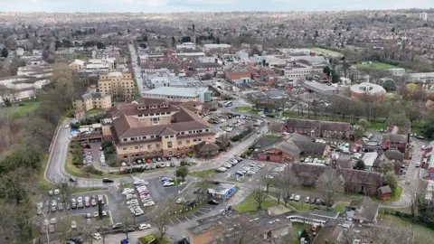 15577ba0-4c43-11f0-a8b1-f318fea9c646 15577ba0-4c43-11f0-a8b1-f318fea9c646 BBC A drone-image of Nottingham City Hospital with city skyline in the background. Car parks and surrounding buildings can be seen in the aerial image How does a £1.6m fine affect an NHS trust? 15577ba0 4c43 11f0 a8b1 f318fea9c646