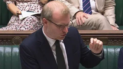 27646670-55dd-11f0-b5c5-012c5796682d 27646670-55dd-11f0-b5c5-012c5796682d BBC Parliament Michael Shanks, the energy minister, addressing the Commons. He is wearing a blue suit, shirt and tie and has his left arm raised slightly as he stands in front of the green benches. Government supporting refinery as 420 jobs at risk 27646670 55dd 11f0 b5c5 012c5796682d