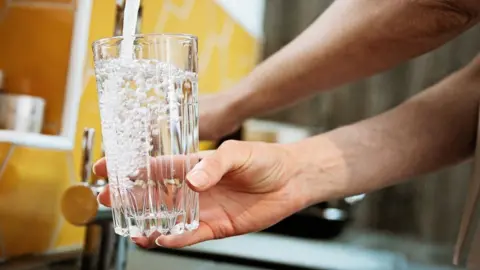 30baf8d0-479e-11f0-84b6-6bf0f66205f1 30baf8d0-479e-11f0-84b6-6bf0f66205f1 Getty Images A woman fills a clear drinking glass with water under the tap. Hot weather: How to sleep in the heat 30baf8d0 479e 11f0 84b6 6bf0f66205f1