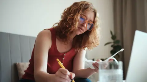378fb040-5353-11f0-8b68-bb939ed7a4d9 378fb040-5353-11f0-8b68-bb939ed7a4d9 Getty Images Young woman with curly hair and glasses sits at her laptop, making notes while looking at bills Lifetime ISAs leave some with less money than they put in 378fb040 5353 11f0 8b68 bb939ed7a4d9