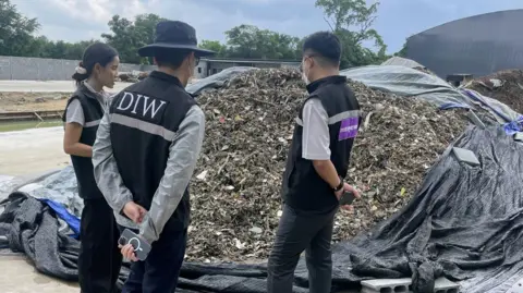 48740370-4cf0-11f0-9604-9d8ffb525450 48740370-4cf0-11f0-9604-9d8ffb525450 BBC Inspectors from Thailand’s industry ministry survey a pile of electronic waste during a raid of an unlicenced recycling plant in eastern Thailand Why your old mobile phone may be polluting Thailand 48740370 4cf0 11f0 9604 9d8ffb525450