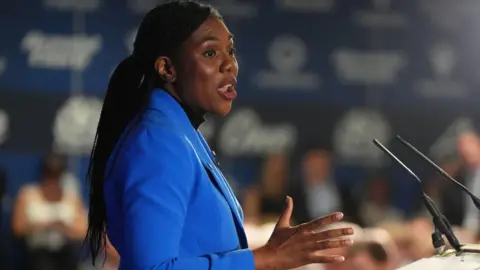 967e9620-484f-11f0-bfce-4fdf1dd09cc7 967e9620-484f-11f0-bfce-4fdf1dd09cc7 PA Media A woman with long hair wearing a bright blue jacket making a speech standing in front of a lectern Badenoch calls for end to oil and gas windfall tax 967e9620 484f 11f0 bfce 4fdf1dd09cc7