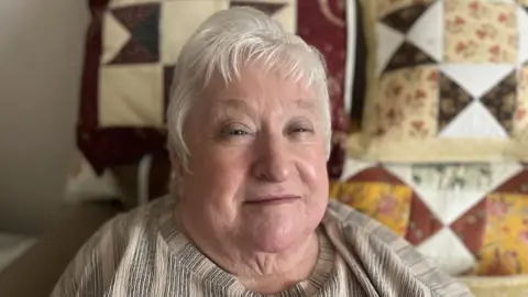 9fa97af0-4550-11f0-a5c1-7195aee68ecb 9fa97af0-4550-11f0-a5c1-7195aee68ecb Margaret Galloway has grey hair parted slightly to the side. Quilted, patterned cushions are visible behind her. NI pensioners could have winter fuel payments restored 9fa97af0 4550 11f0 a5c1 7195aee68ecb