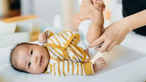 b1088e50-415c-11f0-9fa8-5dd0050201bd b1088e50-415c-11f0-9fa8-5dd0050201bd Getty Images Baby in yellow/white striped vest smiling through a nappy change First bacteria we ever meet can keep us out of hospital b1088e50 415c 11f0 9fa8 5dd0050201bd