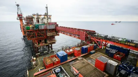 b4d00790-f9d4-11ef-adf5-bddd64abc471 b4d00790-f9d4-11ef-adf5-bddd64abc471 PA Media A general view of an oil rig. The structure is mainly red with a number of multi-coloured shipping crates on the deck. Badenoch calls for end to oil and gas windfall tax b4d00790 f9d4 11ef adf5 bddd64abc471