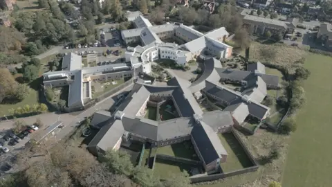 e9d741e0-2a64-11f0-8c66-ebf25fc2cfef e9d741e0-2a64-11f0-8c66-ebf25fc2cfef An aerial photograph shows Goodmayes Hospital from above. Buildings span out from a central circular area. It is surrounded by grass and trees. We quit our jobs, sold our home twice and spent 10 years fighting for the truth e9d741e0 2a64 11f0 8c66 ebf25fc2cfef
