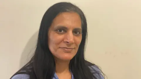 Rashida Anwar Rashida Anwar with long black hair wearing a blue top with a neutral expression standing against a plain cream wall  Summer holiday club costs: &#039;It&#039;s the amount you&#039;d spend going away&#039; fb406910 6255 11f0 a369 c988e8a1d1b1
